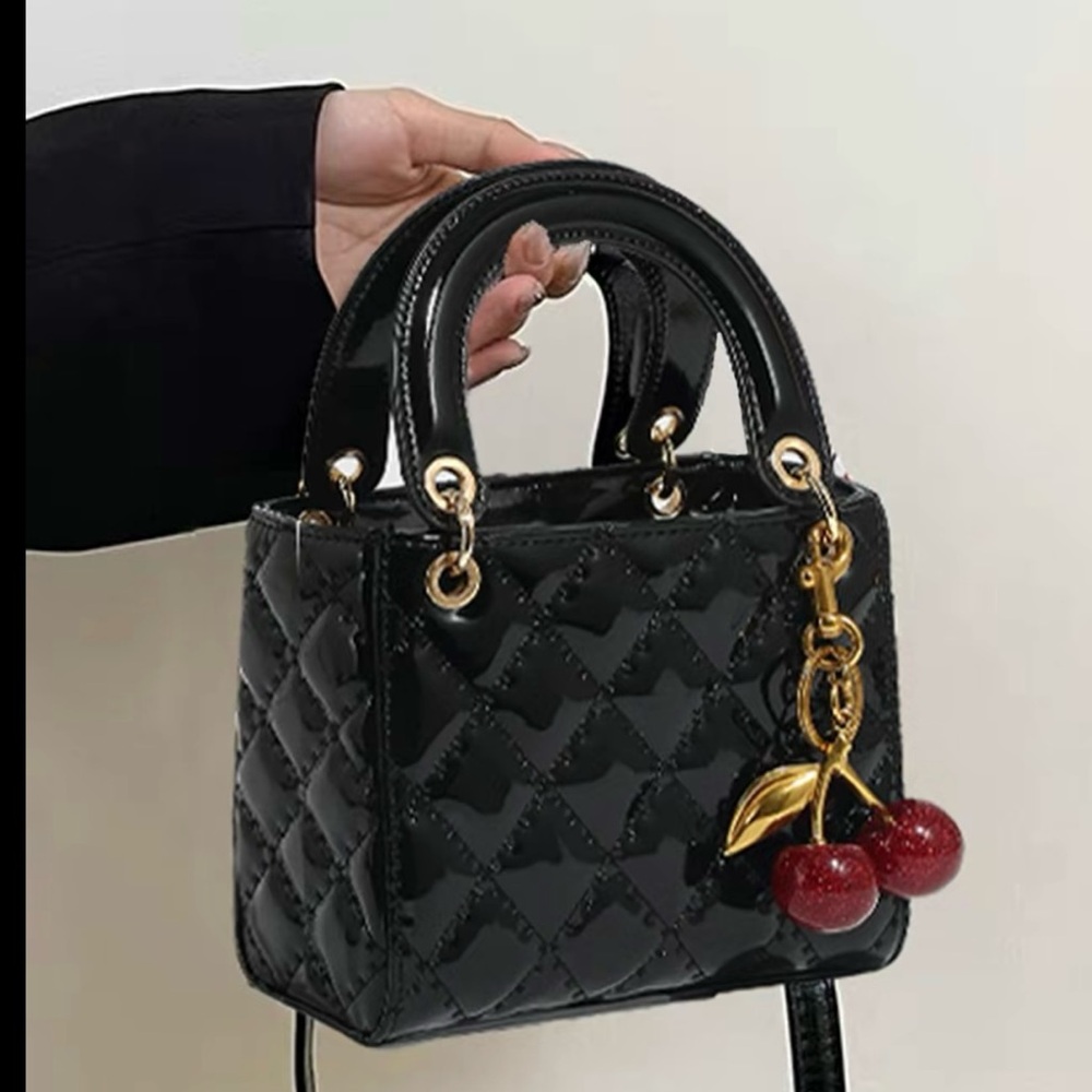 Elegant Black Quilted Handbag with Cherry Charm